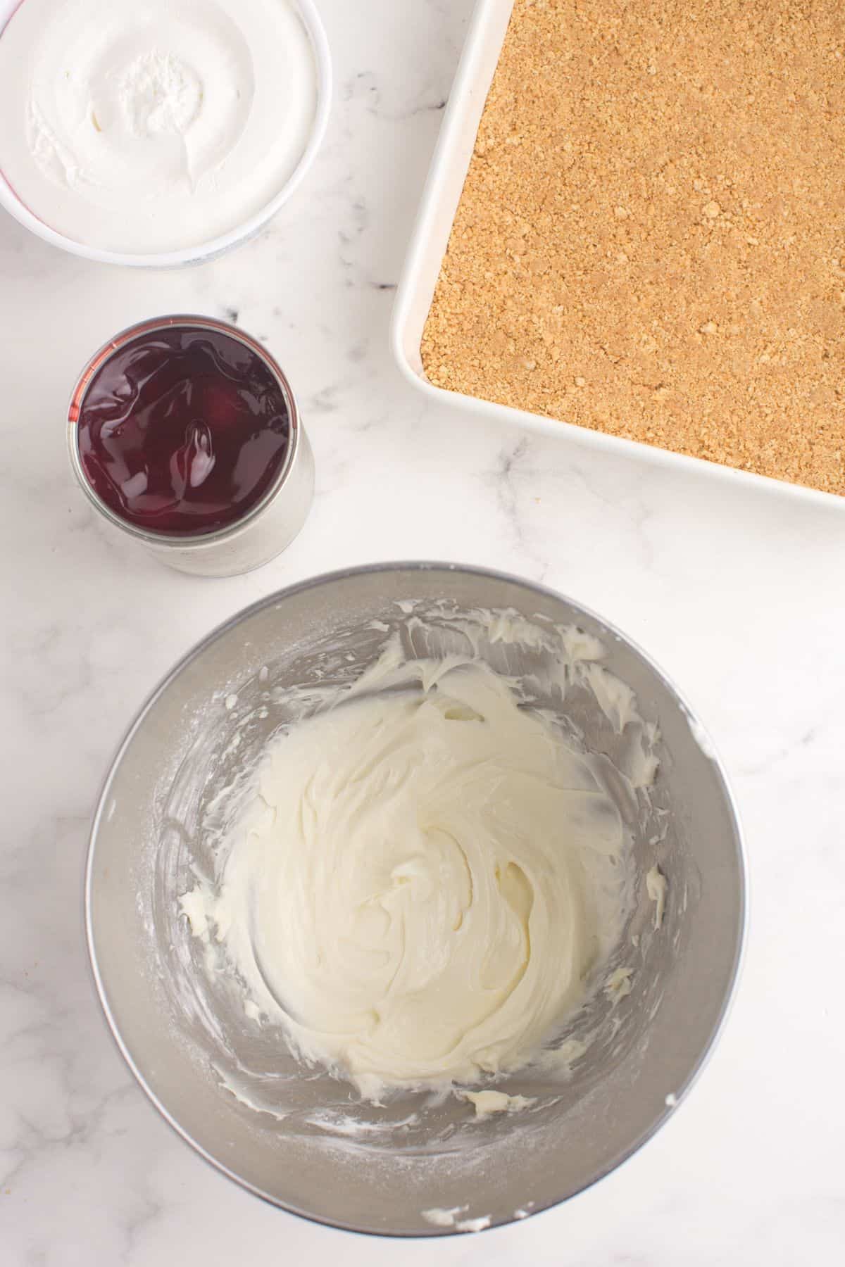 Cream cheese whipped in a mixing bowl.