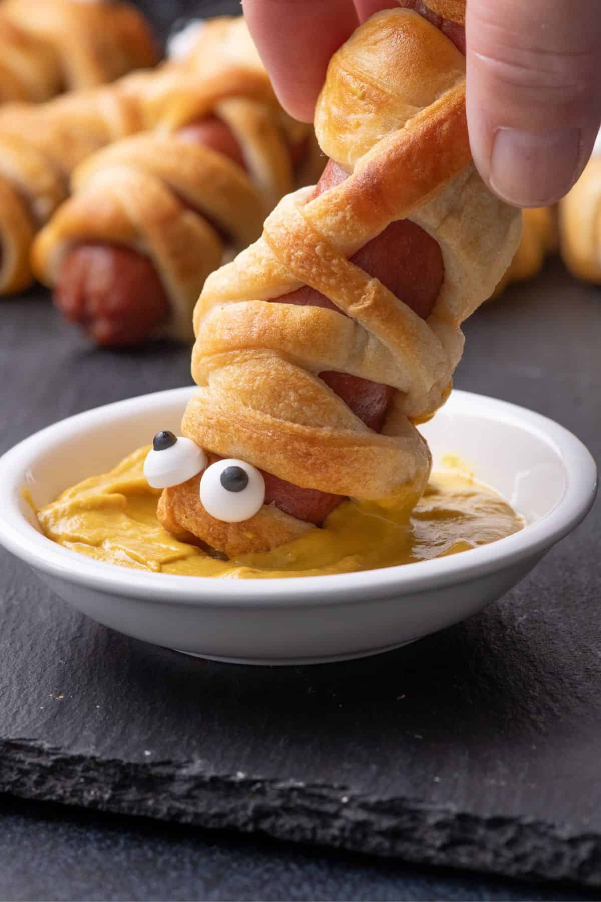 Hot dog mummy dipped in mustard.