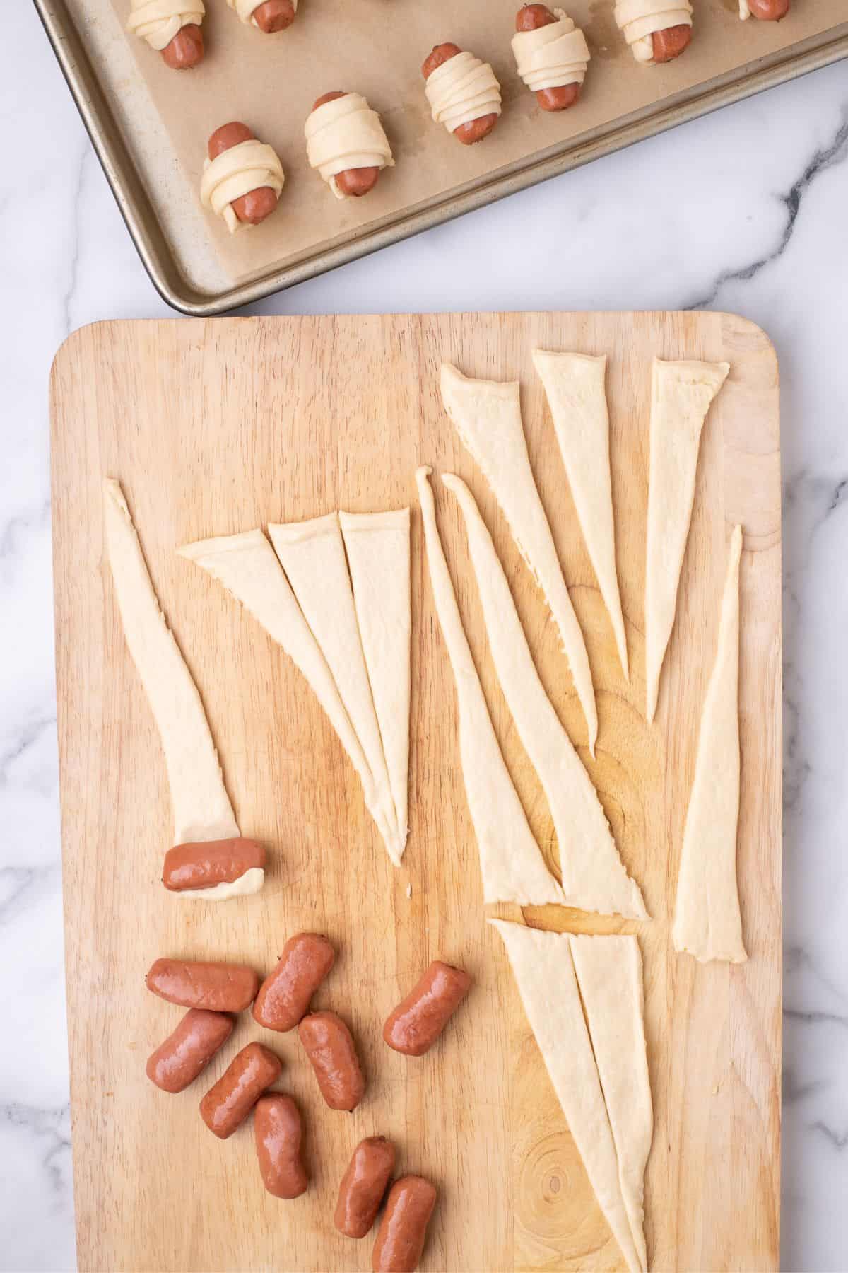Lil smokies are rolled from the thick end of the triangle to the thin end.