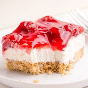 Close up of a piece of the cherry delight recipe with a forkful taken from it.