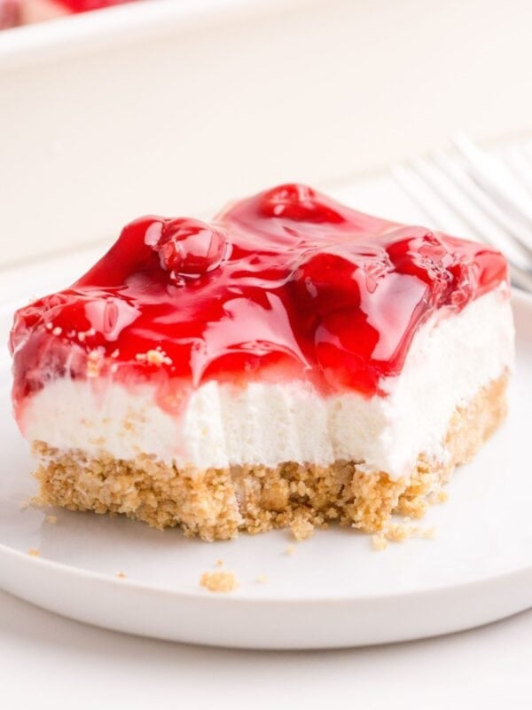 Close up of a piece of the cherry delight recipe with a forkful taken from it.