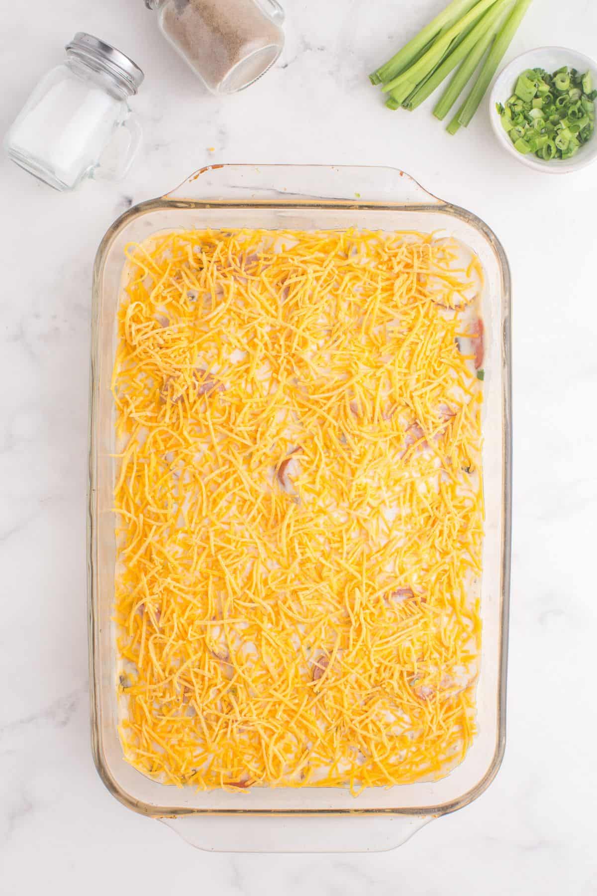 Cheese added on top of the pierogi and kielbasa casserole.