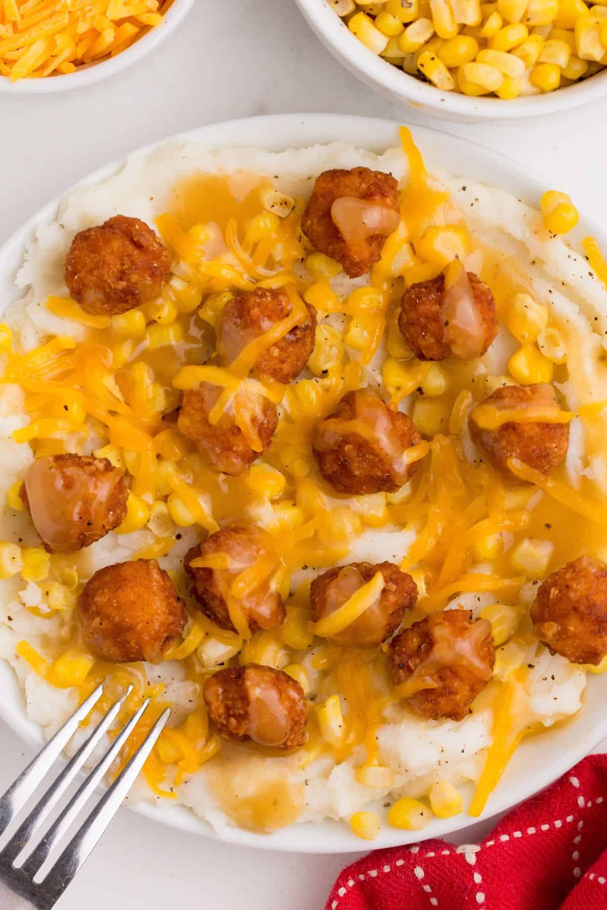 Over top view of the KFC bowl recipe with popcorn chicken and mashed potatoes in a bowl.